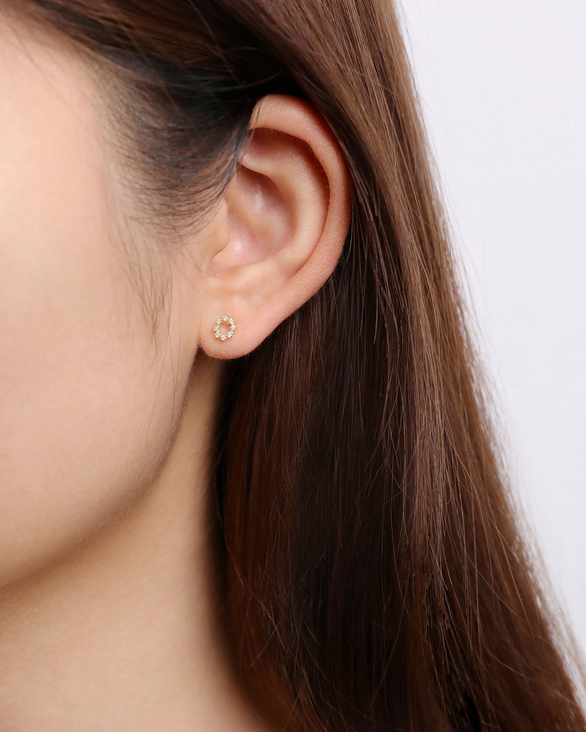Model wearing circular cubic zirconia earring from Minimalist Touch Earrings Set in 925 sterling silver.
