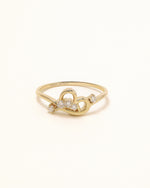Luminous Heart Ring in solid gold with sparkling moissanite on a soft neutral background.