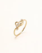 Luminous Heart Ring in solid gold with open heart details and round moissanite stones.