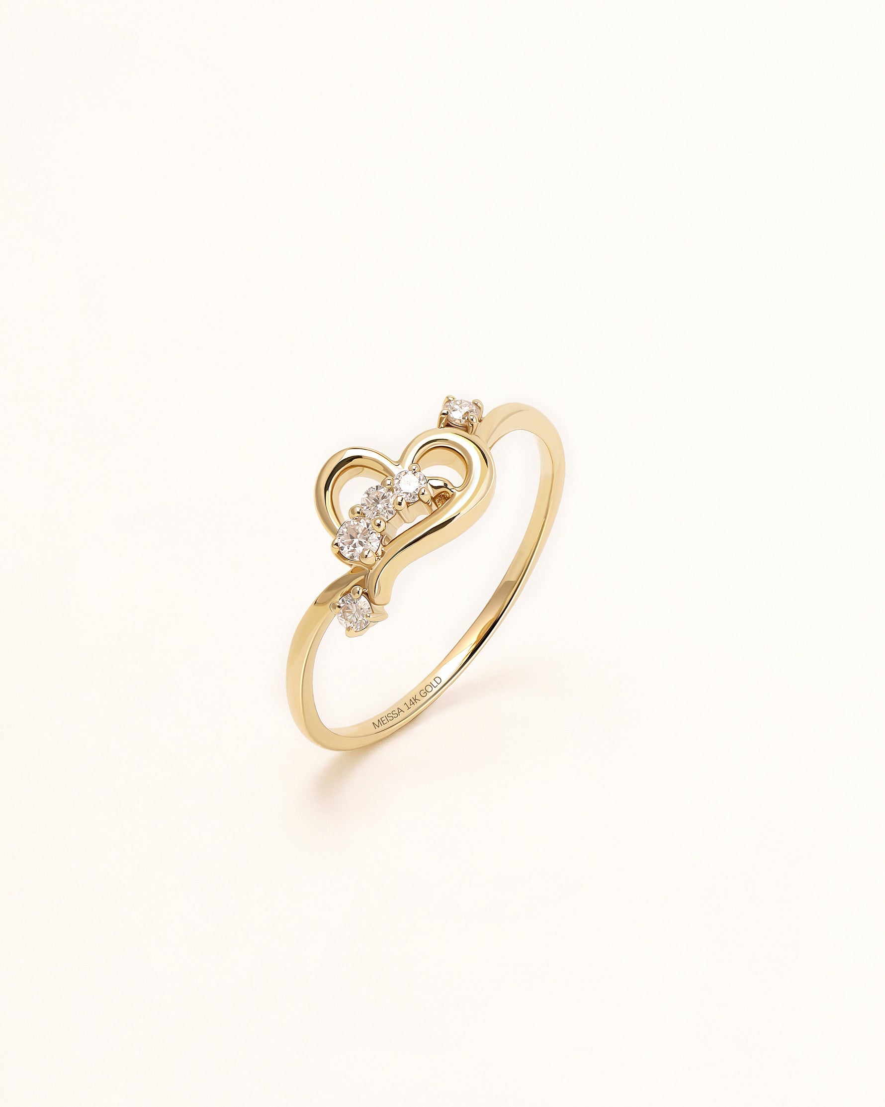 Luminous Heart Ring in solid gold with open heart details and round moissanite stones.