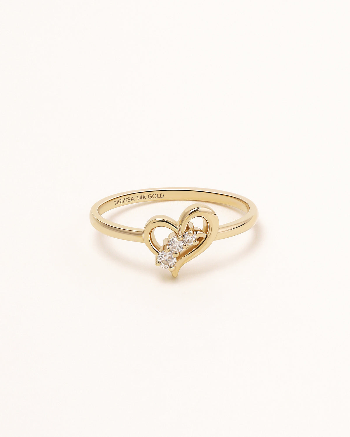 Front view of Waves of Love Ring in solid gold with three round moissanite stones.