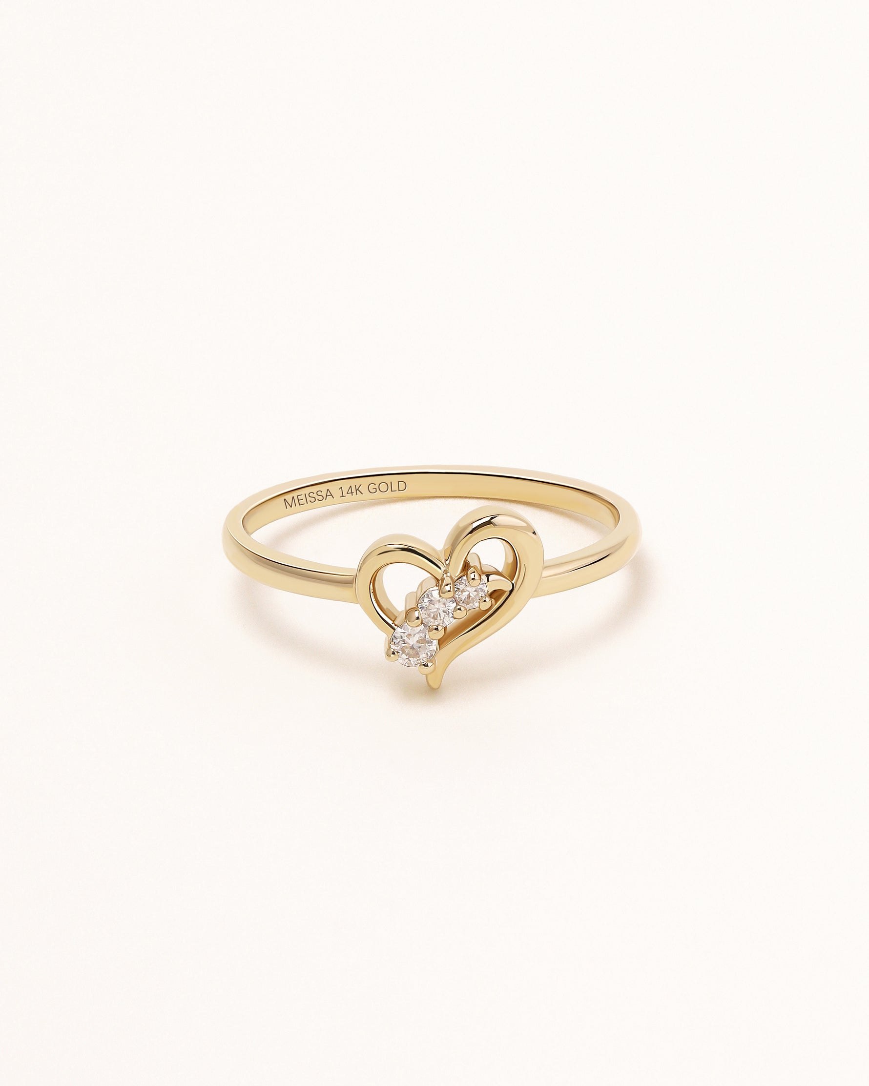 Front view of Waves of Love Ring in solid gold with three round moissanite stones.