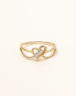 Front view of Wings of the Heart Ring in solid gold with open heart centerpiece and sparkling moissanite stones.
