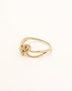 Side view of Wings of the Heart Ring in solid gold showing the heart setting and delicate double band design.