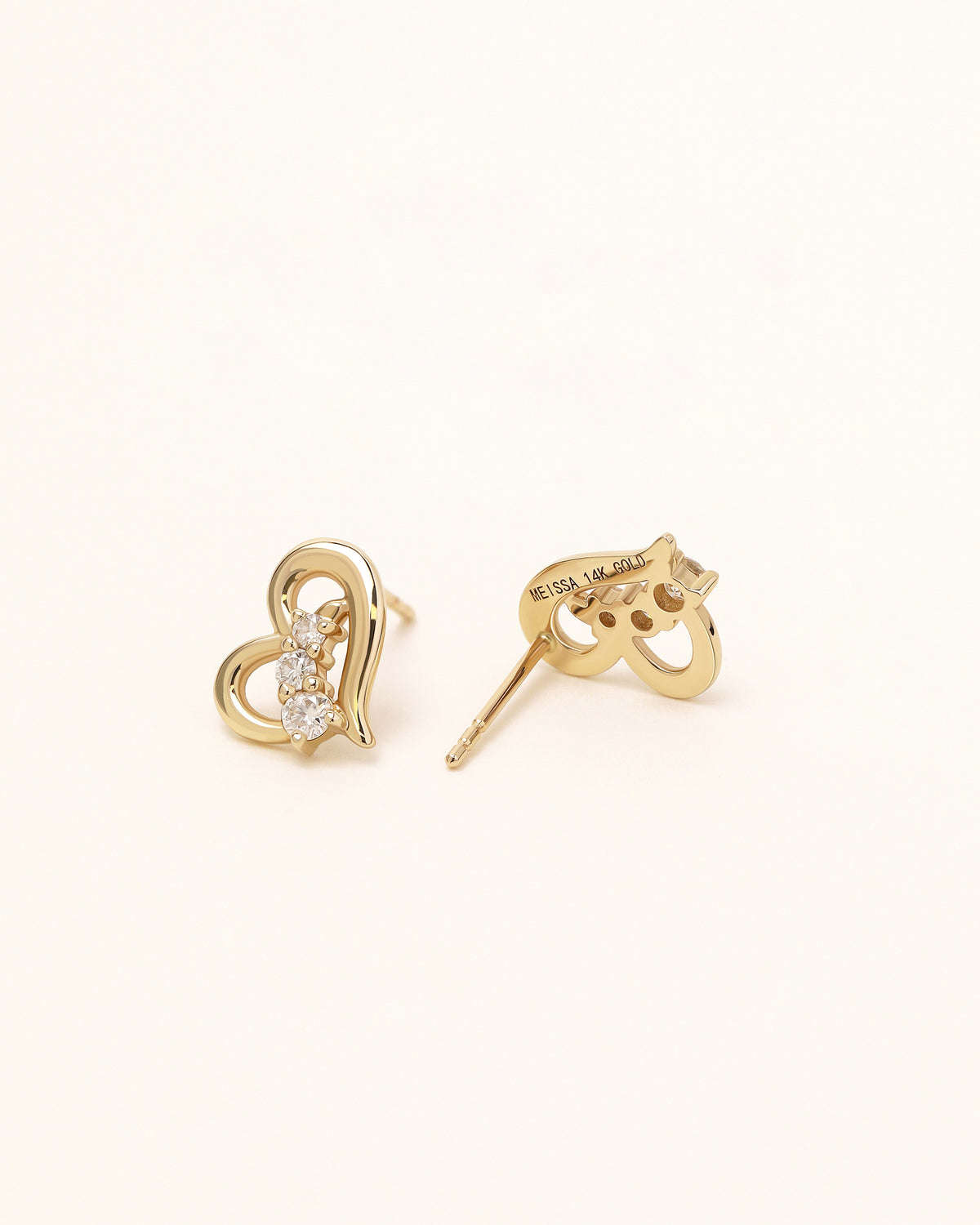 Heart of Freedom Stud Earrings in solid gold showing the back setting and 14K gold engraving.