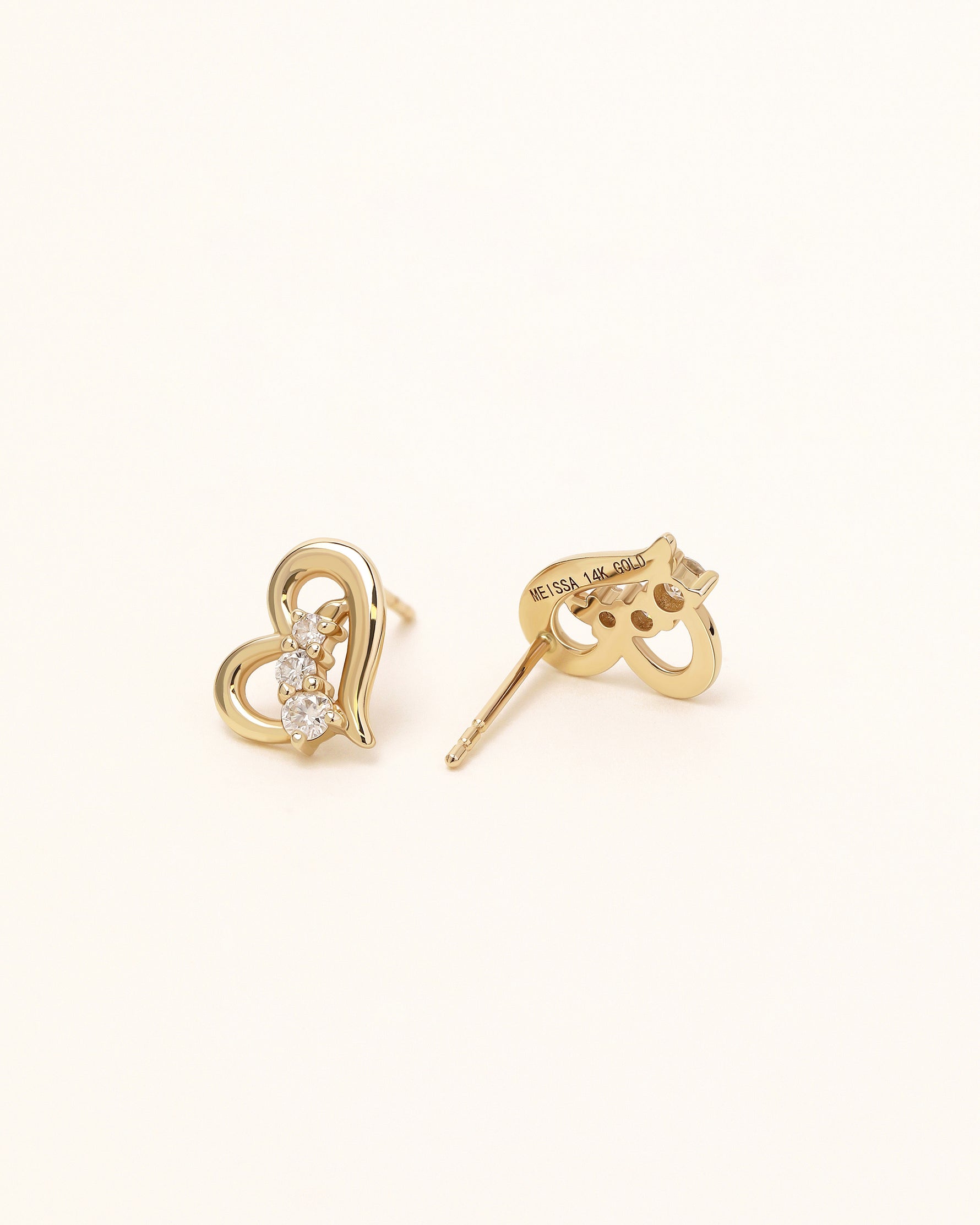 Heart of Freedom Stud Earrings in solid gold showing the back setting and 14K gold engraving.
