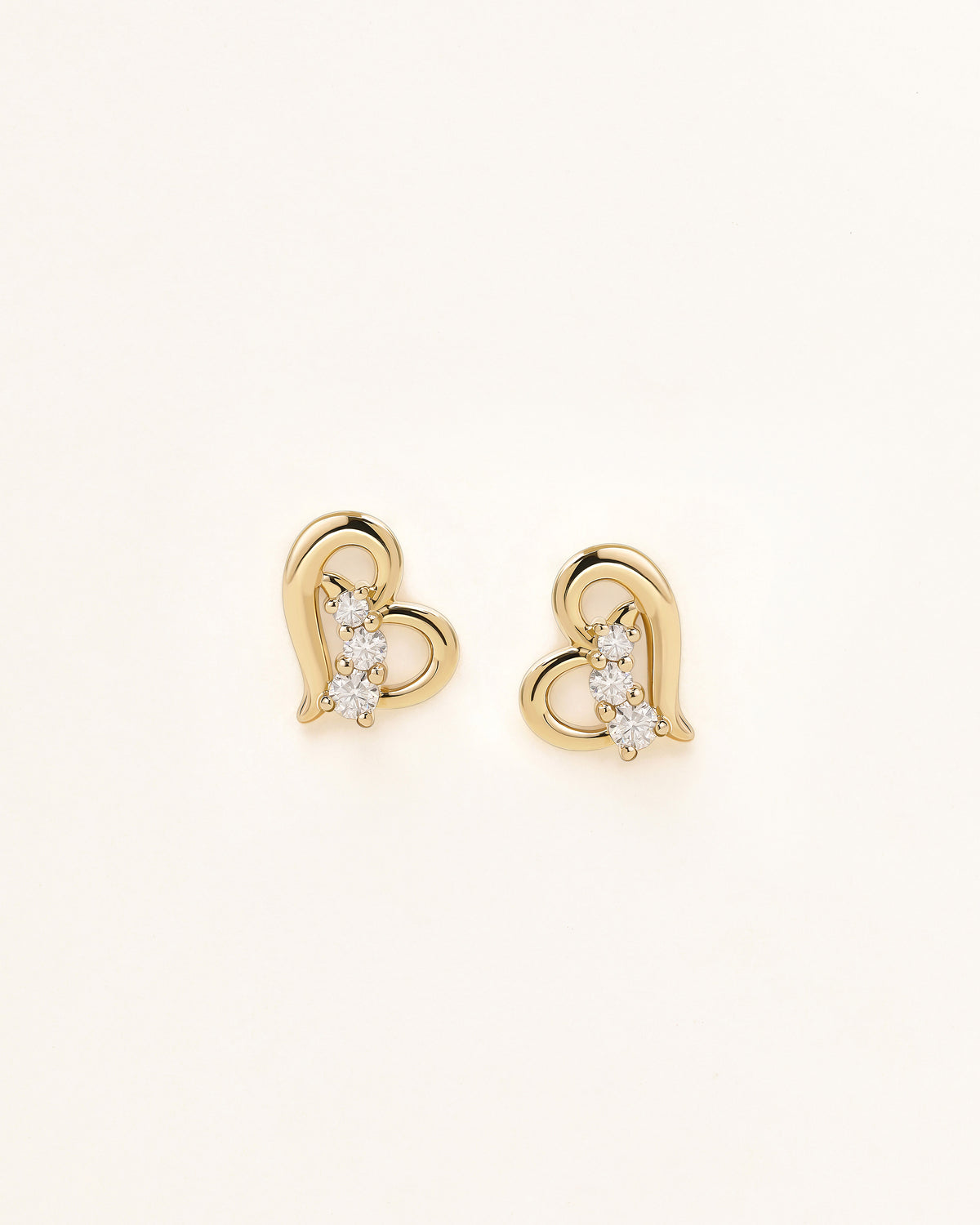 Front view of Heart of Freedom Stud Earrings in solid gold with heart motif and three moissanite stones.