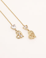 Front view of Heart of Freedom Threader Earrings in solid gold with long chain threader design and heart details.