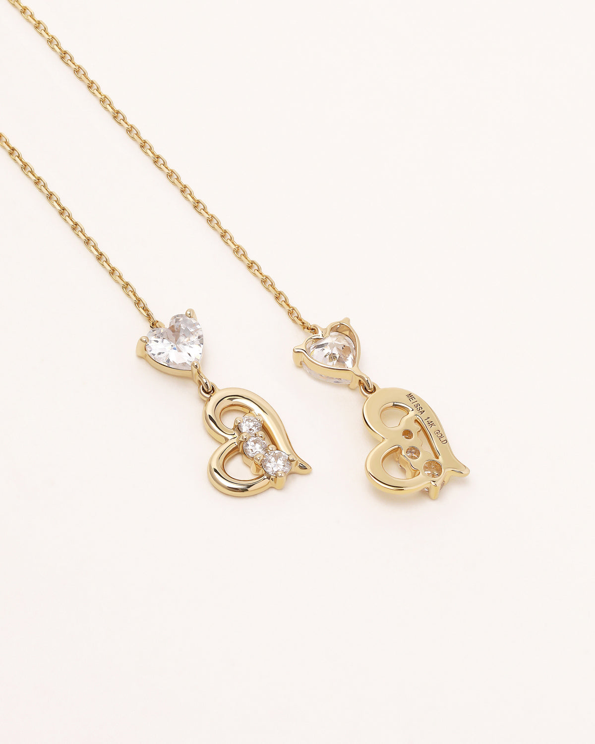 Front view of Heart of Freedom Threader Earrings in solid gold with long chain threader design and heart details.