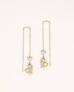 Front view of Heart of Freedom Threader Earrings in solid gold with long chain threader design and heart details.