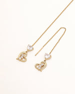 Heart of Freedom Threader Earrings in solid gold with heart-shaped moissanite and open heart charms on fine chains.