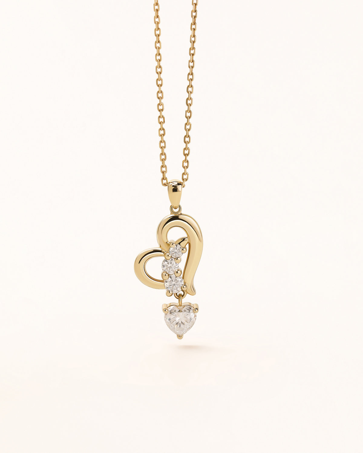 Front view of Dancing Heart Necklace in solid gold with open heart design and moissanite stones.