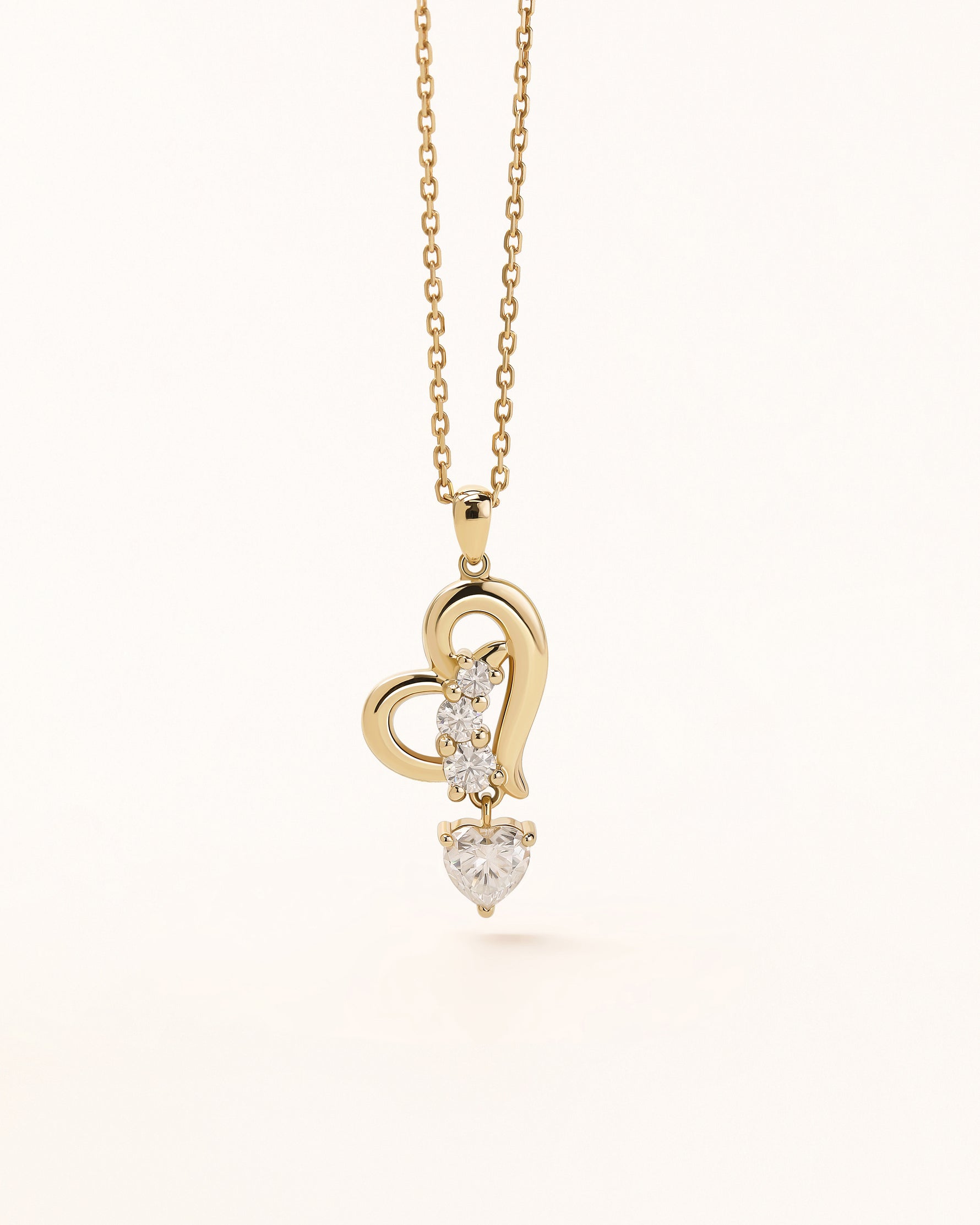 Front view of Dancing Heart Necklace in solid gold with open heart design and moissanite stones.
