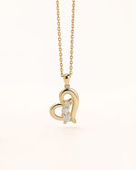 Close-up of Meissa Heart of Freedom Necklace in solid gold with an open heart pendant and three sparkling moissanite stones.