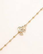 Back view of Heart of Freedom Bracelet in solid gold showing Meissa 14K gold engraving and heart-shaped moissanite setting.