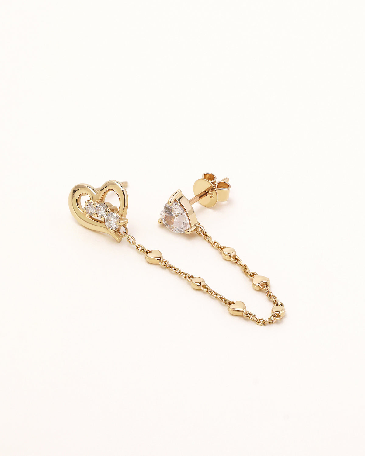 Side view of Heart of Freedom Chain Earrings in solid gold showing heart-shaped moissanite studs and decorative heart chain links.