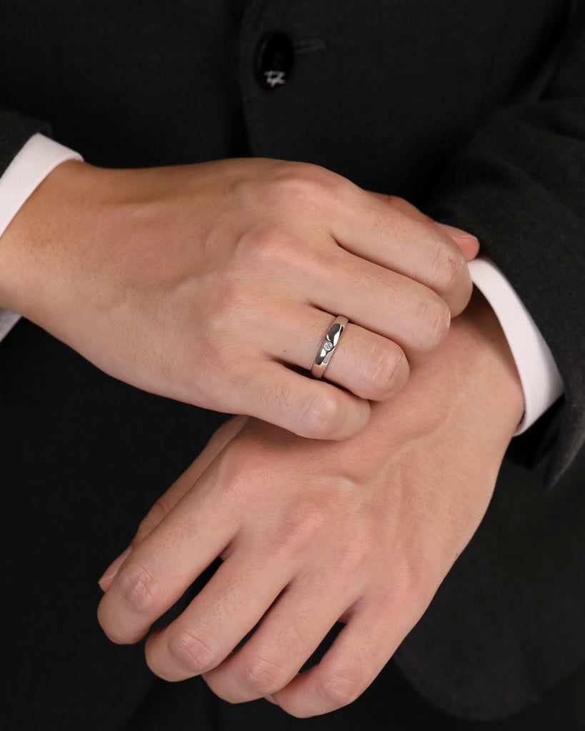 Close-up of hands with a ring on a black background