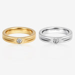 Nova Track Ring in stainless steel shown in gold and silver finishes with a round cubic zirconia center stone and polished groove details.