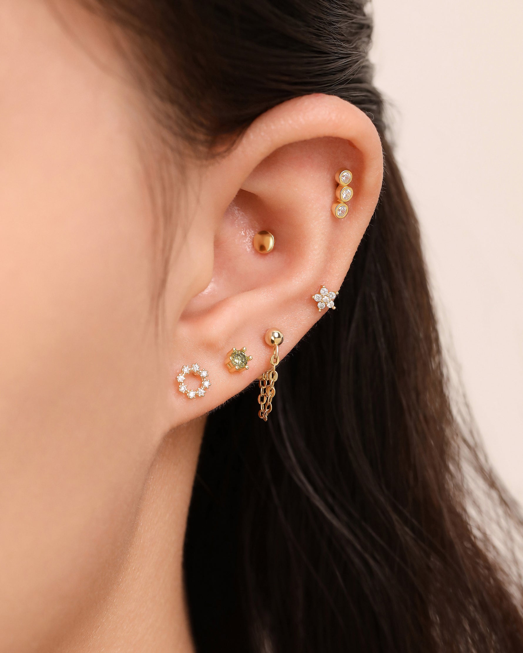 Model wearing Minimalist Touch Earrings Set in 925 sterling silver with layered gold-tone screw back earrings.