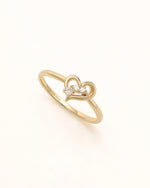 Angled view of Waves of Love Ring in solid gold with heart motif and moissanite accents.