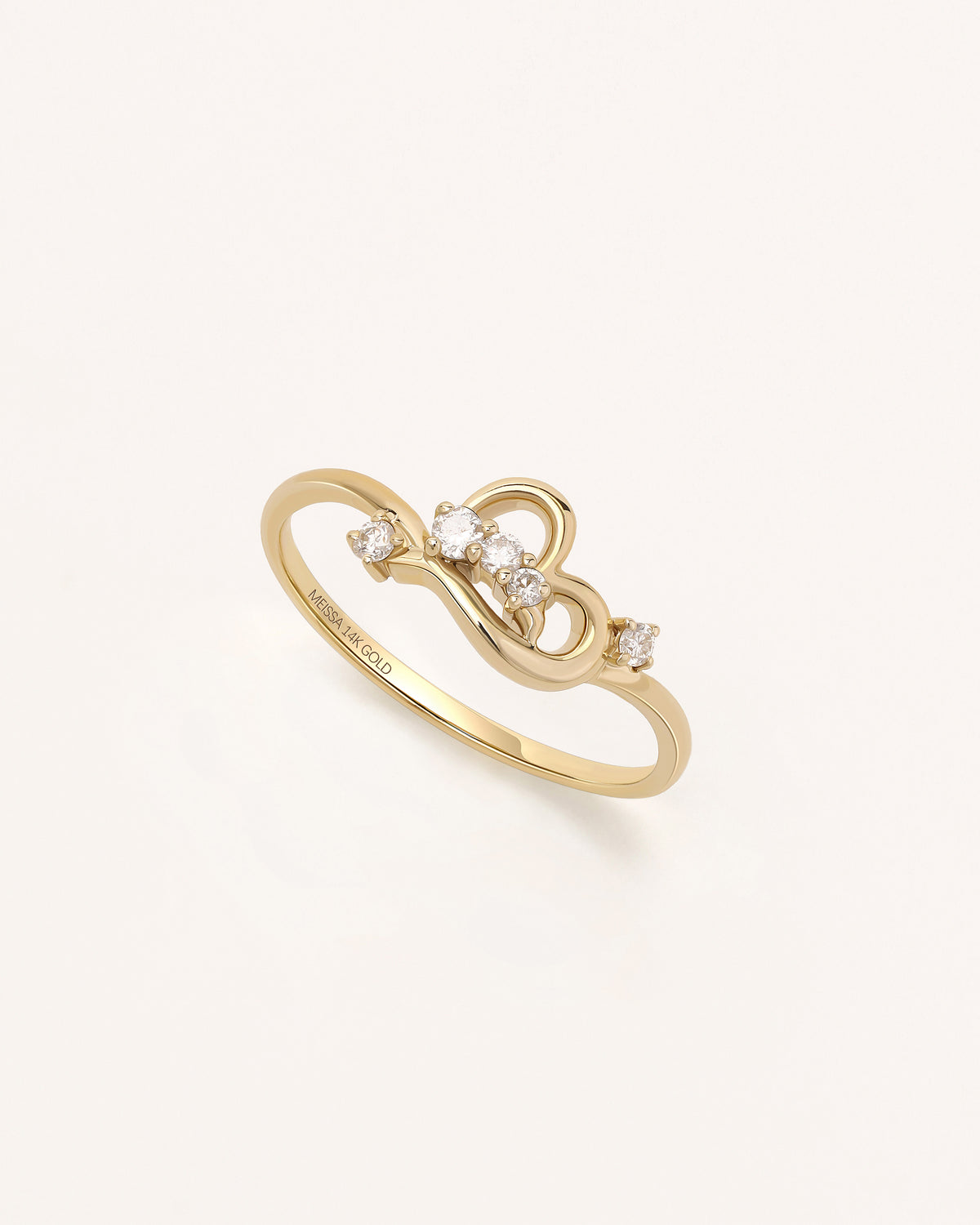 Angled view of Luminous Heart Ring in solid gold with heart motif and moissanite stones.