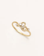 Angled view of Luminous Heart Ring in solid gold with heart motif and moissanite stones.