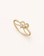 Angled view of Wings of the Heart Ring in solid gold with layered heart motif and moissanite accents.