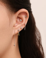 Model wearing Chain Chic Earrings Set in 925 sterling silver with layered stud, chain and drop earrings.
