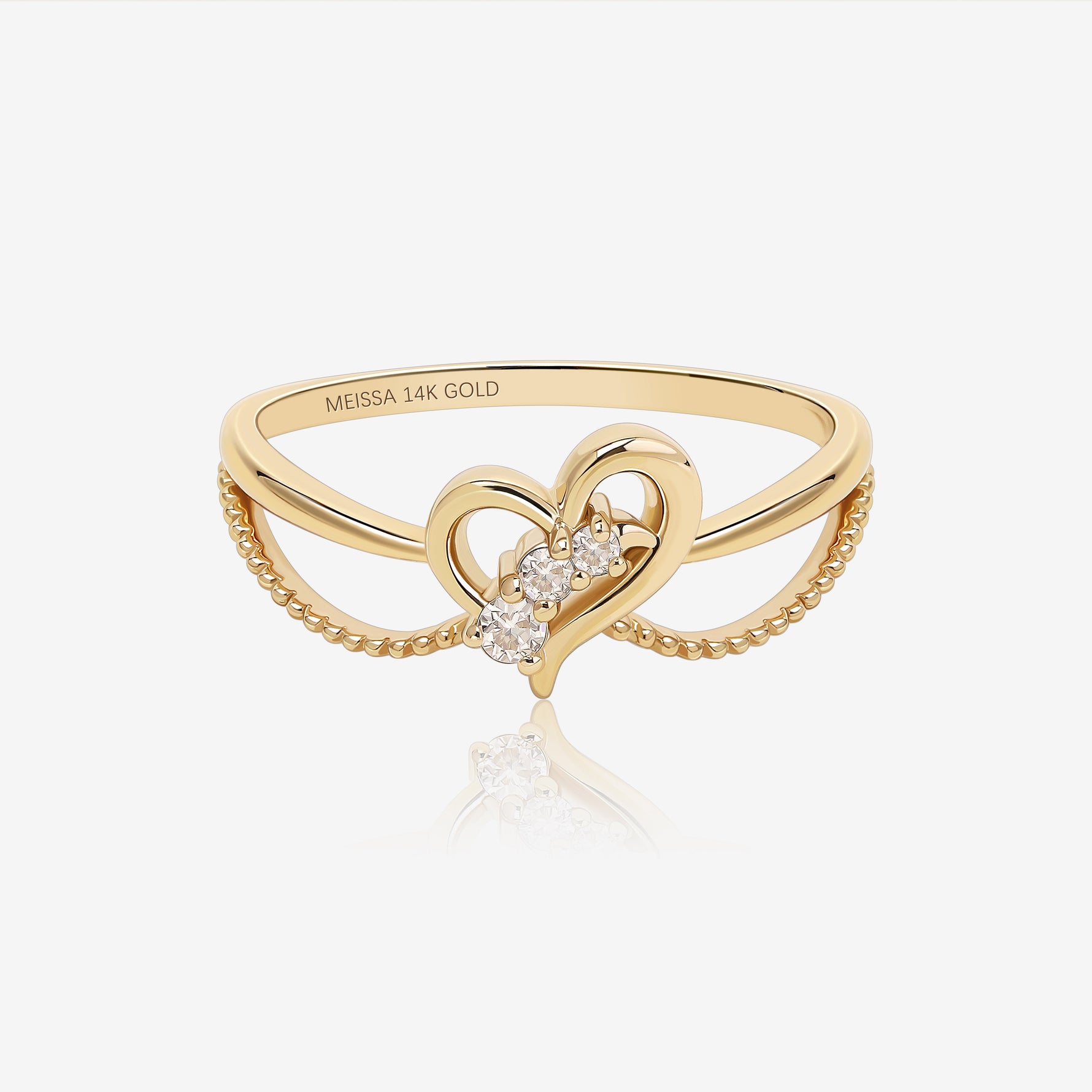 Wings of the Heart Ring in solid gold with an open heart design, moissanite stones and delicate double band details.