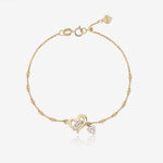 Heart of Freedom Bracelet in solid gold with open heart centerpiece, moissanite stones and delicate beaded chain.