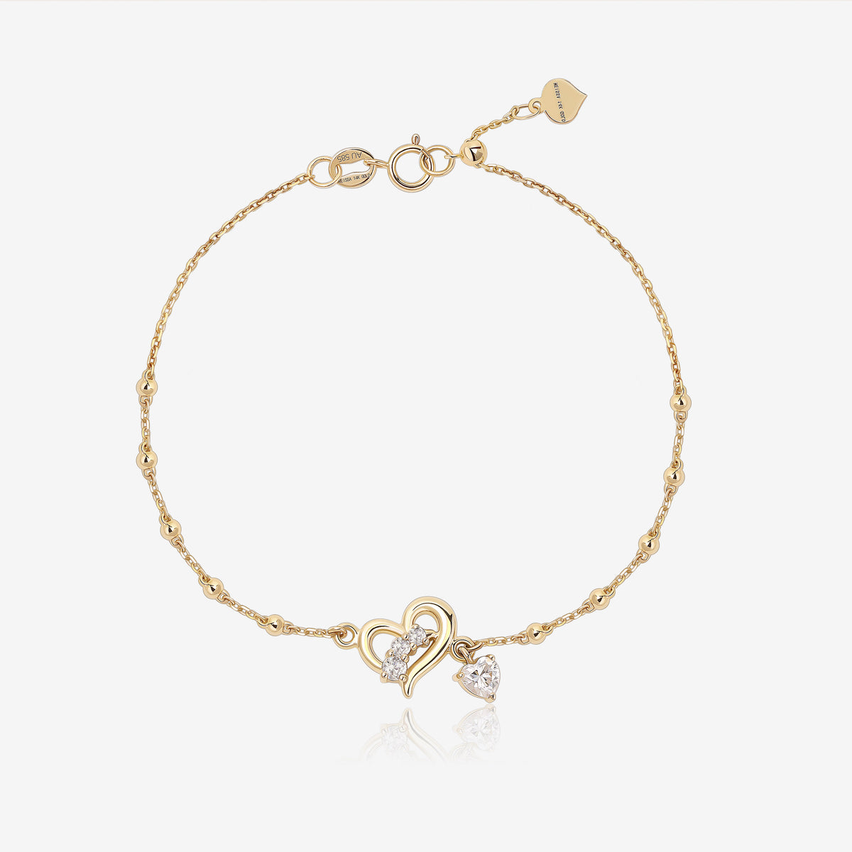 Heart of Freedom Bracelet in solid gold with open heart centerpiece, moissanite stones and delicate beaded chain.