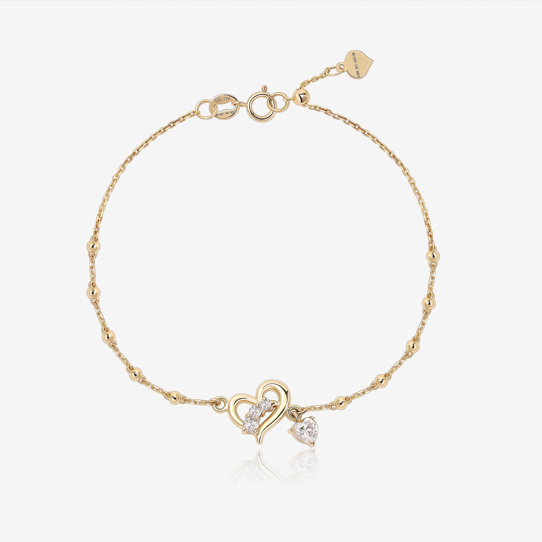Heart of Freedom Bracelet in solid gold with open heart centerpiece, moissanite stones and delicate beaded chain.
