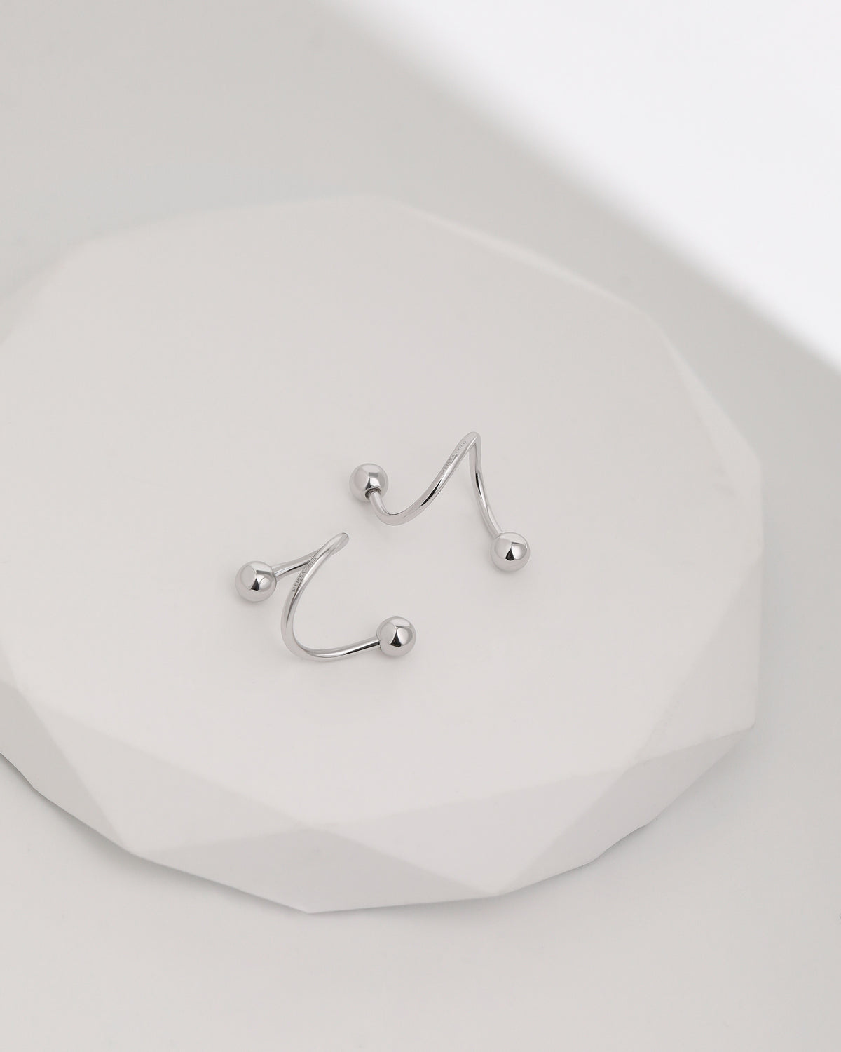 Ball Spiral Screw Back Earrings in 18K solid gold displayed on a white surface, highlighting the sculptural spiral design and polished ball ends.
