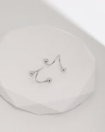 Ball Spiral Screw Back Earrings in 18K solid gold displayed on a white surface, highlighting the sculptural spiral design and polished ball ends.
