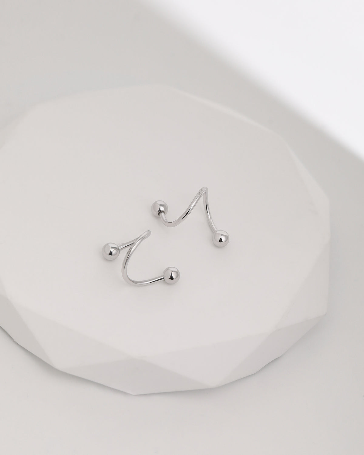 Ball Spiral Screw Back Earrings in 925 sterling silver displayed on a white surface, highlighting the sculptural spiral design and polished ball ends.