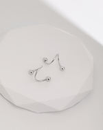Ball Spiral Screw Back Earrings in 925 sterling silver displayed on a white surface, highlighting the sculptural spiral design and polished ball ends.