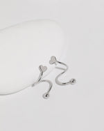 Heart Spiral Screw Back Earrings in silver color displayed from multiple angles, highlighting the smooth spiral curves, polished heart ends, and round screw back balls.