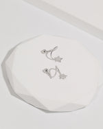 Star Spiral Screw Back Earrings in silver color displayed on a white jewelry platform, featuring star ends, curved spiral posts, and round screw backs.