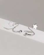 Star Spiral Screw Back Earrings in silver color shown close up on a white platform with polished five-point stars and round screw ball backs.