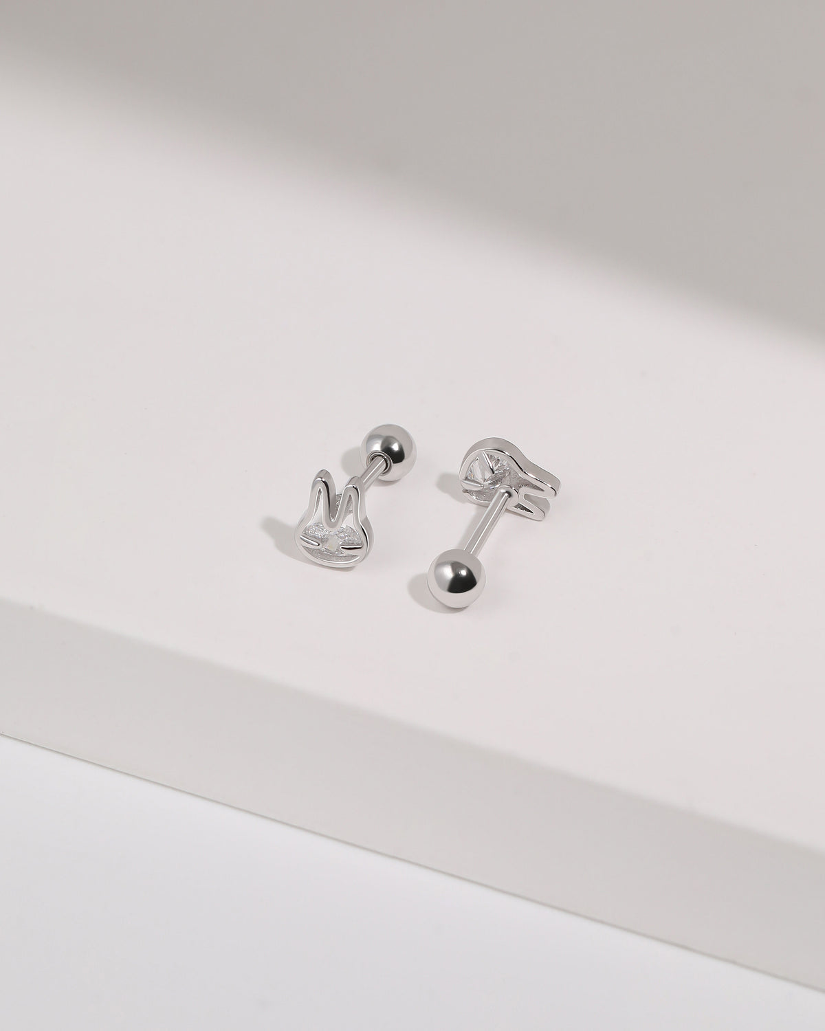 Pair of silver Meissa Bunny Sparkle Screw Back Earrings shown from front and back angles with round screw backs on a white surface.