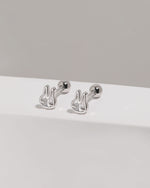 Pair of silver Meissa Bunny Sparkle Screw Back Earrings with clear cubic zirconia displayed on a white platform with round screw backs visible.