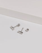 Twist Bar Screw Back Earrings shown with one round screw back removed, revealing the threaded post and screw closure construction.