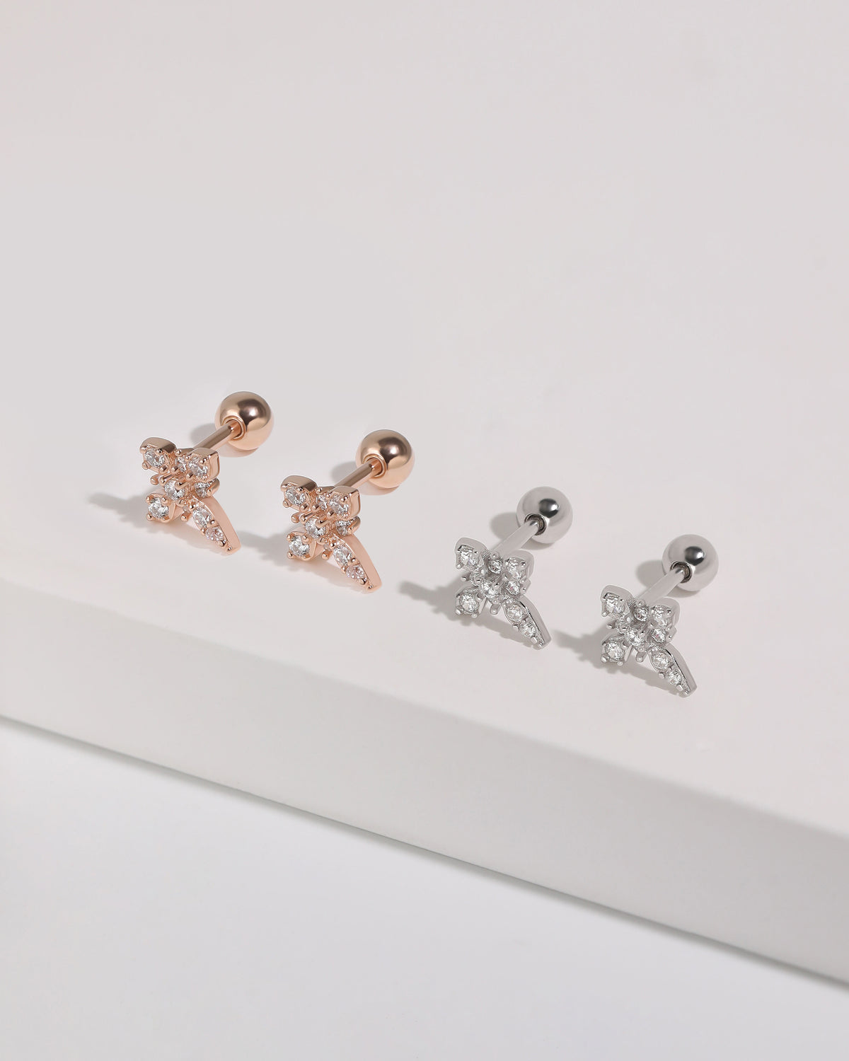 Cross Sparkle Screw Back Earrings in rose gold and silver, featuring sparkling cubic zirconia cross designs and round screw back closures.