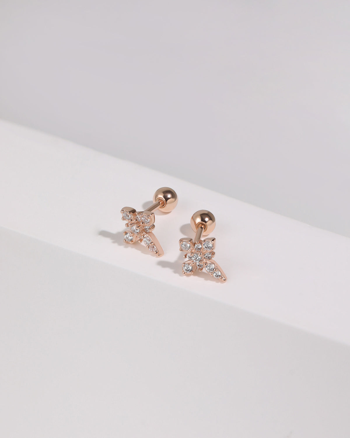 Pair of rose gold Cross Sparkle Screw Back Earrings with sparkling cubic zirconia cross fronts and polished round screw backs.