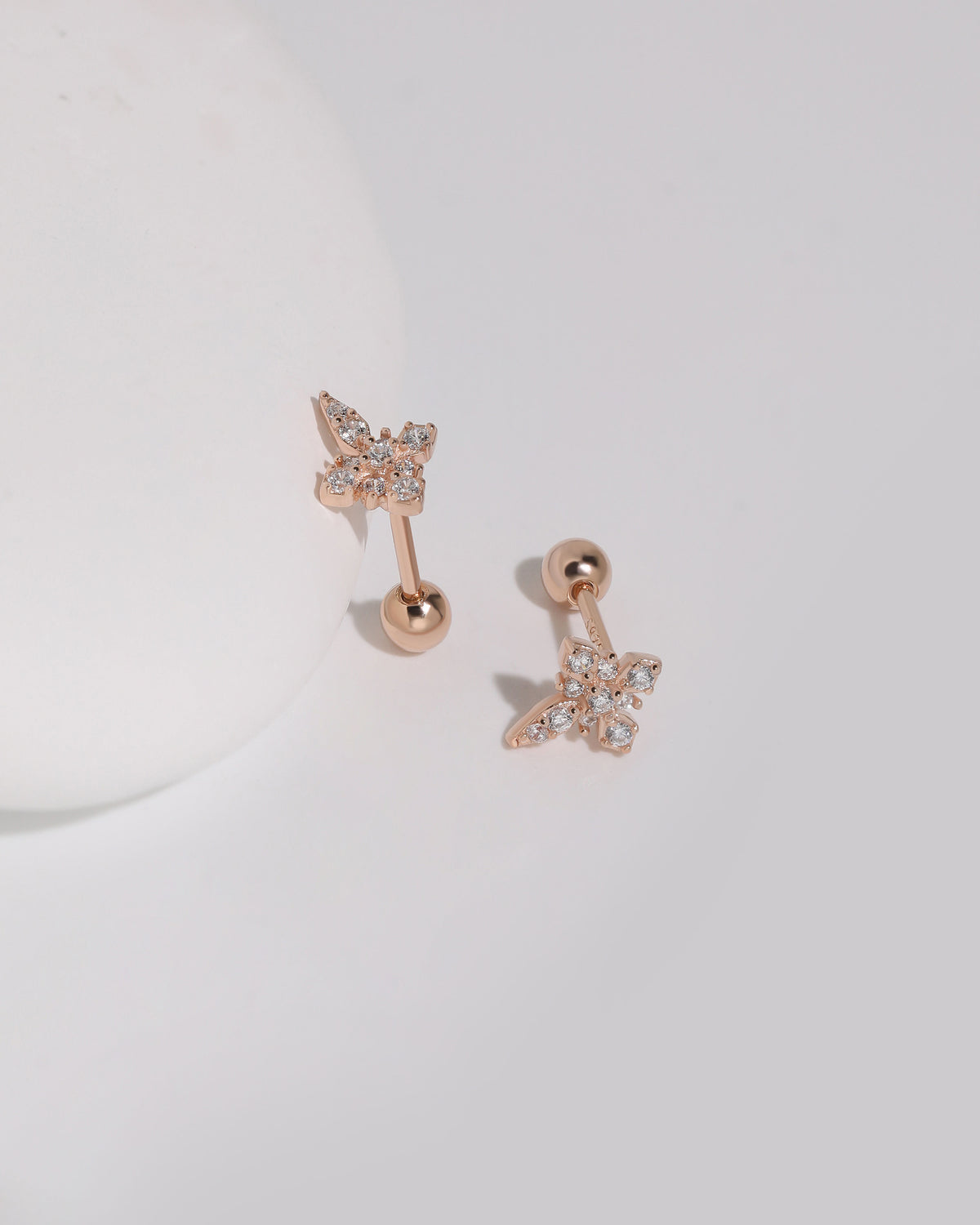 Rose gold Cross Sparkle Screw Back Earrings displayed from different angles, highlighting the cubic zirconia cross design and round screw backs.