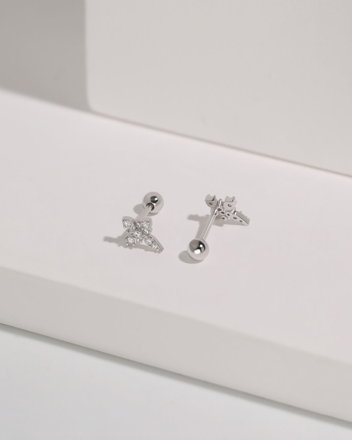 Pair of silver Cross Sparkle Screw Back Earrings displayed on a white surface with sparkling cubic zirconia cross designs and round screw backs.