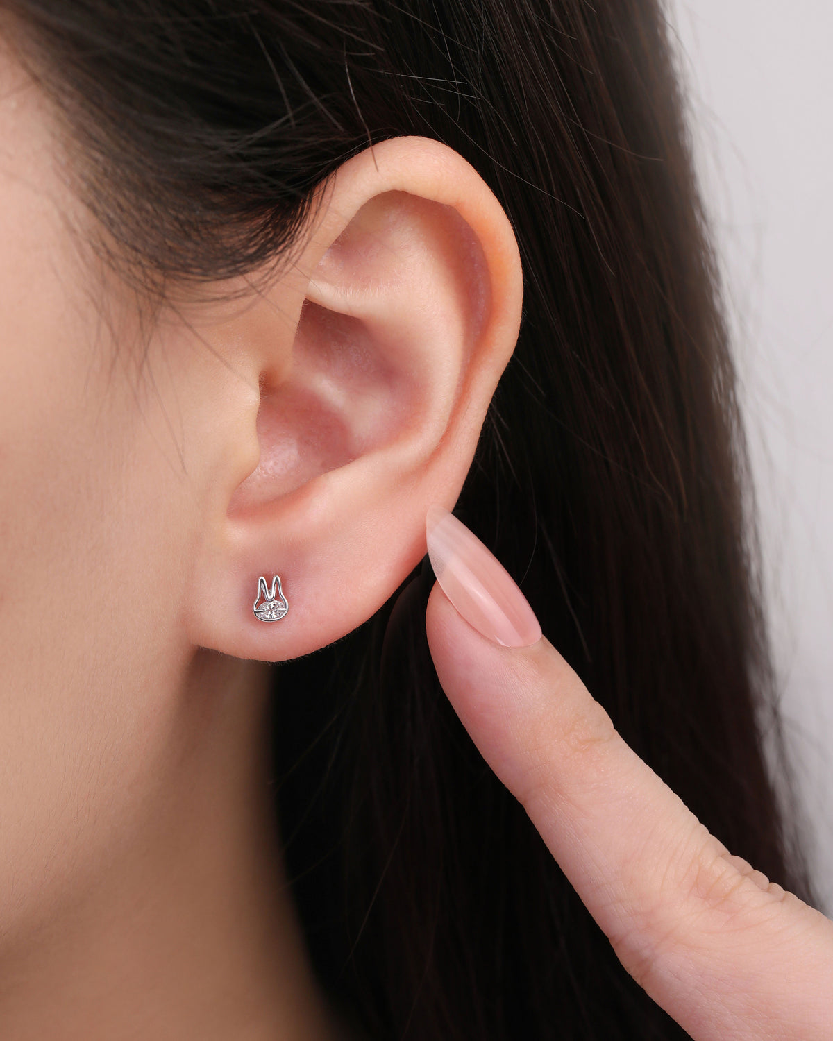 Close-up of a model wearing a silver Meissa Bunny Sparkle Screw Back Earring with a clear cubic zirconia center.