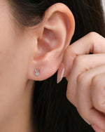 Model wearing a silver Meissa Bunny Sparkle Screw Back Earring featuring a small bunny outline and clear cubic zirconia.