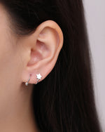 Star Spiral Screw Back Earring worn on the ear with a polished star detail and curved spiral design shown in a close-up styling view.