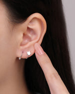 Star Spiral Screw Back Earring worn on the earlobe, showing the polished star front and spiral curve wrapping around the ear.